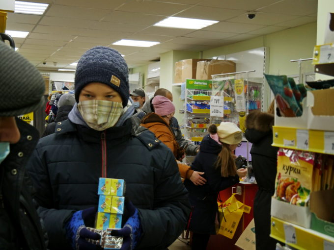 A boy holds a boxes of matches in an Avrora store in Ukraine on 2 March, 2022